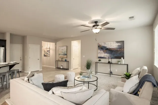 a living room with furniture and a chandelier