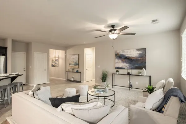 a living room with furniture and a chandelier