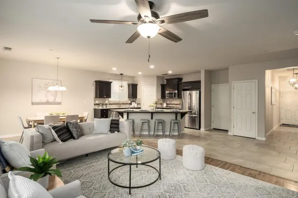 a living room with furniture kitchen view and a table
