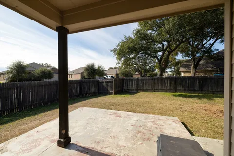 a view of a house with backyard and trees