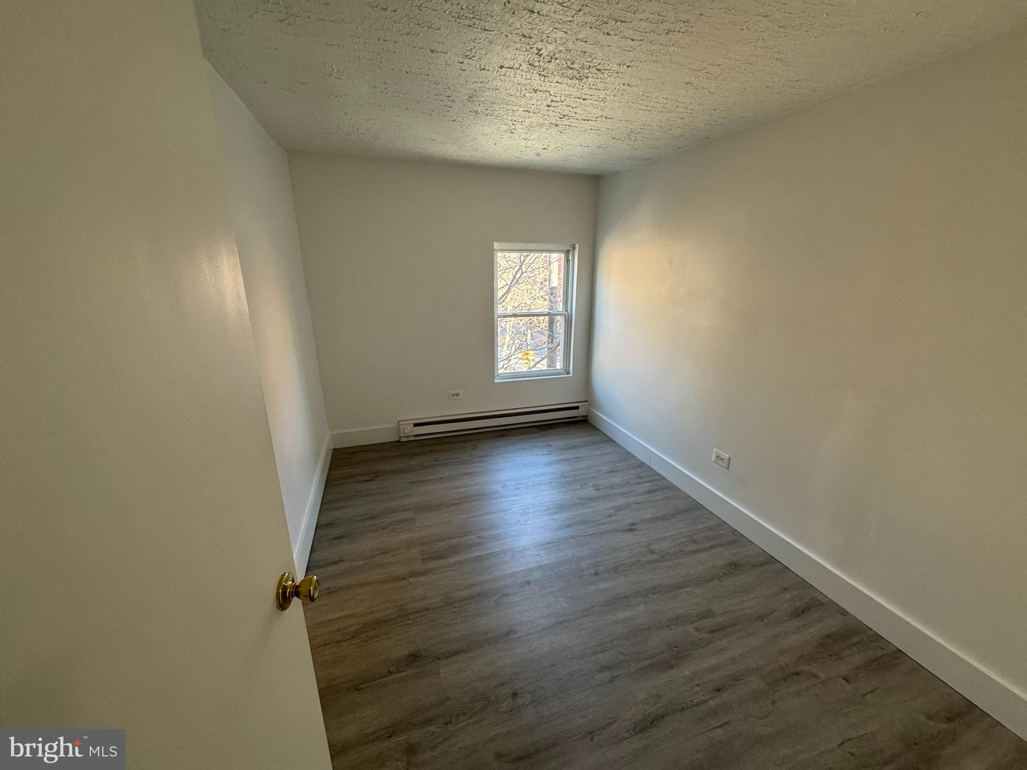 1600-2 Pine Street, Unit 3A Philadelphia, PA 19103 - Photo 4 of 10 an empty room with wooden floor and windows