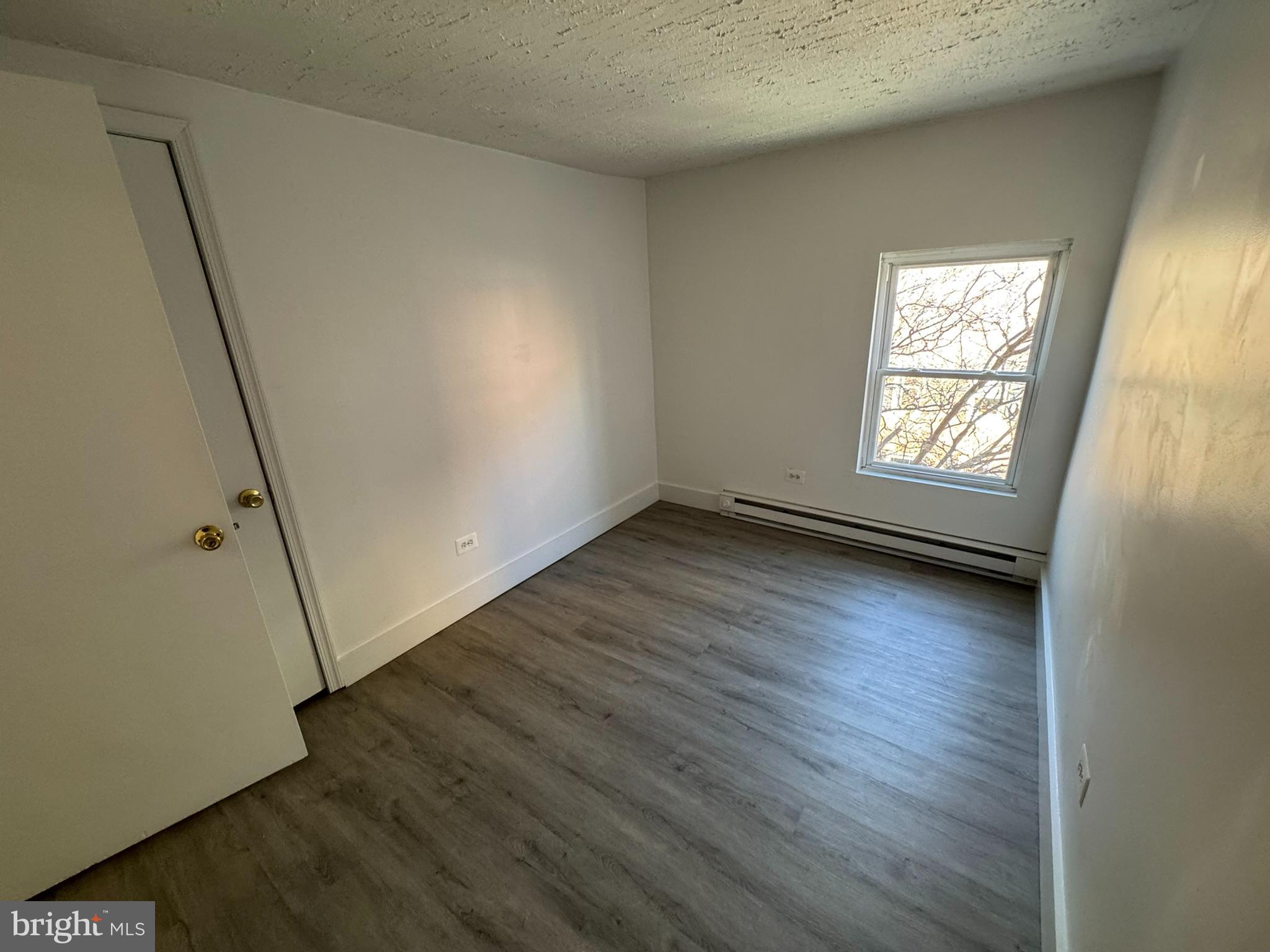 1600-2 Pine Street, Unit 3A Philadelphia, PA 19103 - Photo 5 of 10 an empty room with wooden floor and window