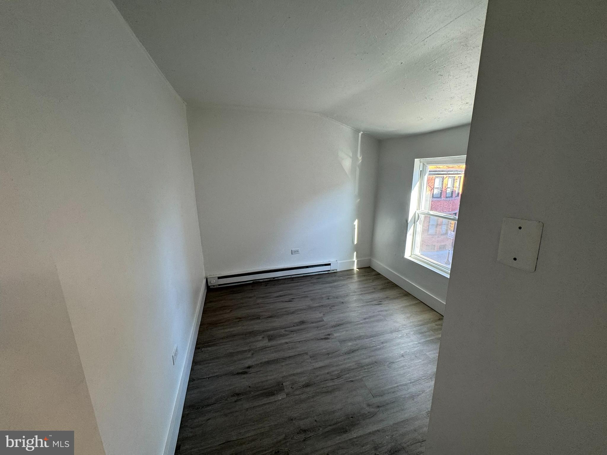 1600-2 Pine Street, Unit 3A Philadelphia, PA 19103 - Photo 7 of 10 an empty room with wooden floor and windows