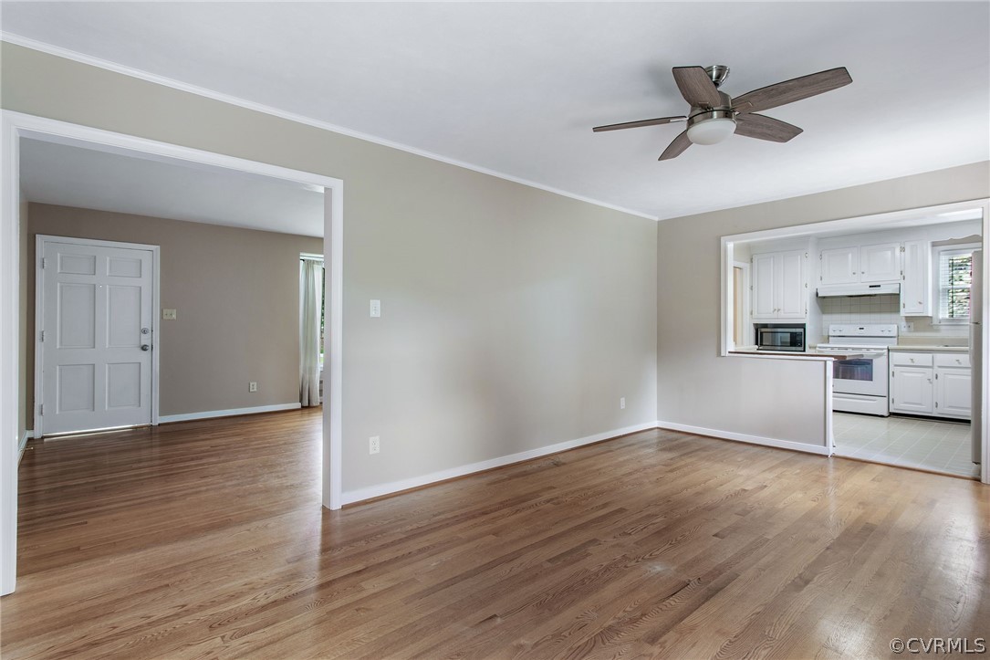 3316 Cheverly Road Richmond, VA 23225 - Photo 17 of 33 a view of a livingroom with a ceiling fan & wooden floor
