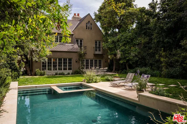 a house with swimming pool in front of it