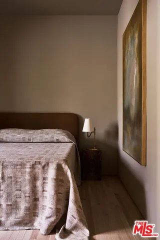 a bed sitting in a bedroom next to a window