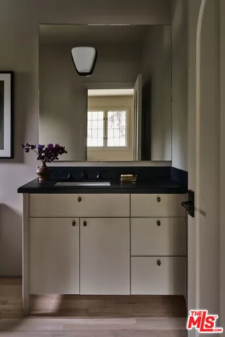 a bathroom with a sink and a mirror