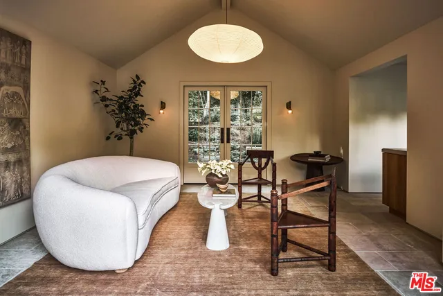 a living room with a table and chairs
