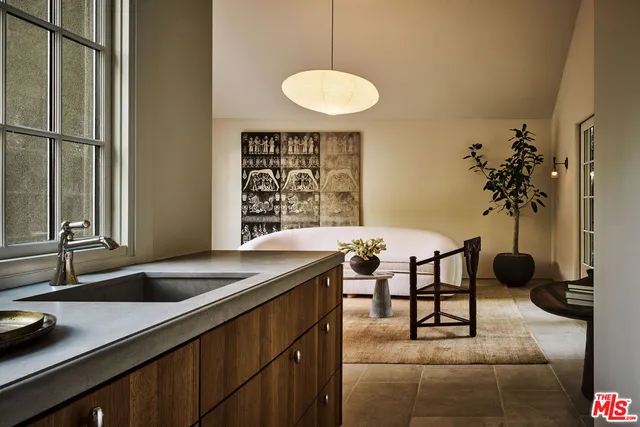 a kitchen with a sink a counter and a dining table