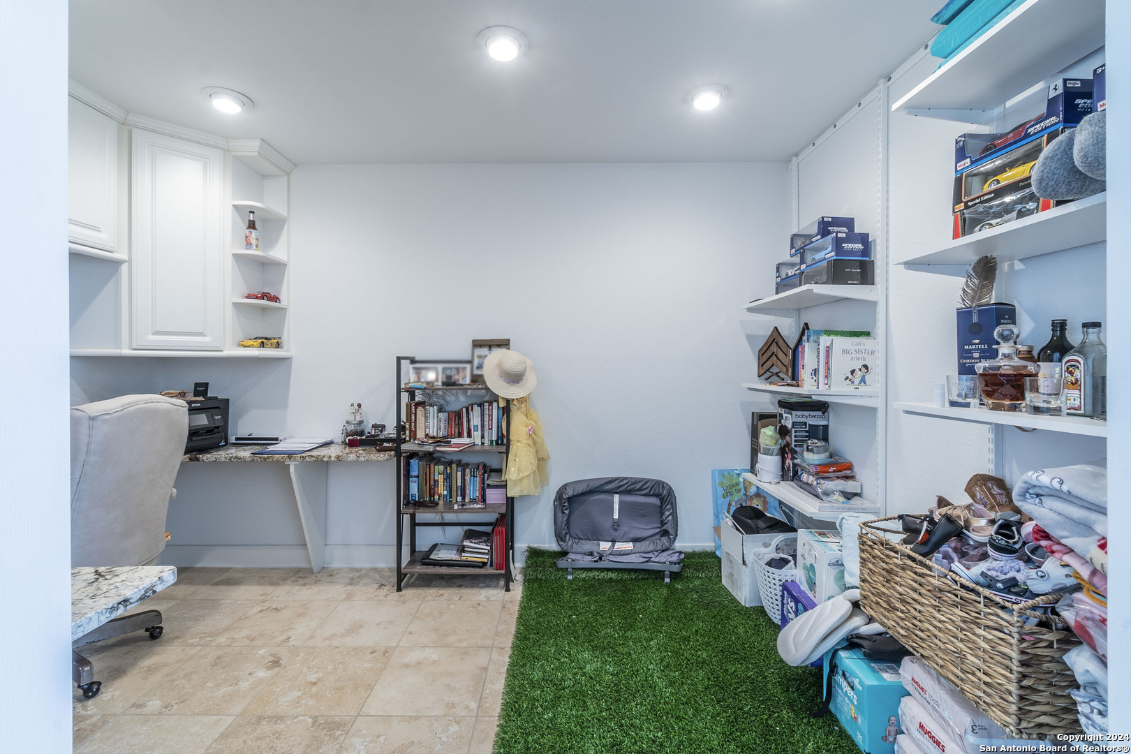 7701 Wurzbach Road, Unit 2302 San Antonio, TX 78229 - Photo 17 of 40 a living room with furniture and a book shelf