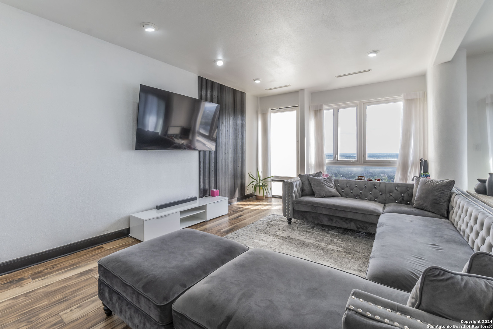 7701 Wurzbach Road, Unit 2302 San Antonio, TX 78229 - Photo 3 of 40 a living room with furniture and a flat screen tv