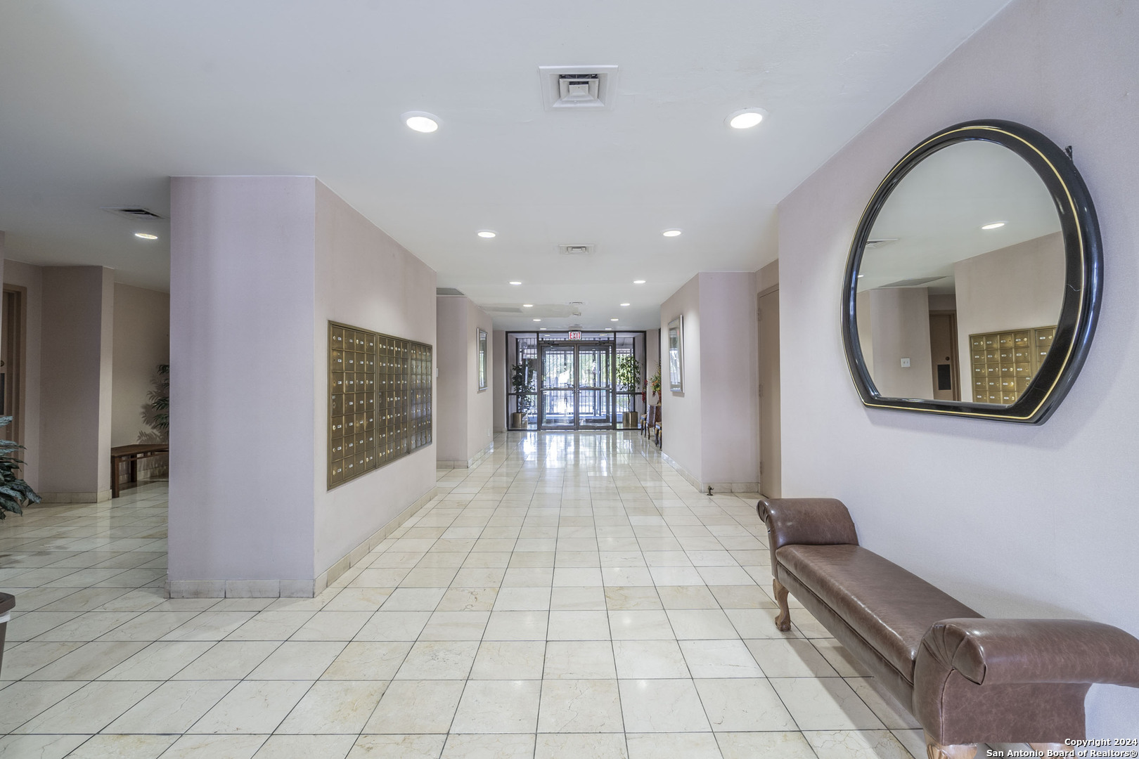 7701 Wurzbach Road, Unit 2302 San Antonio, TX 78229 - Photo 32 of 40 a lobby with furniture and a wooden floor