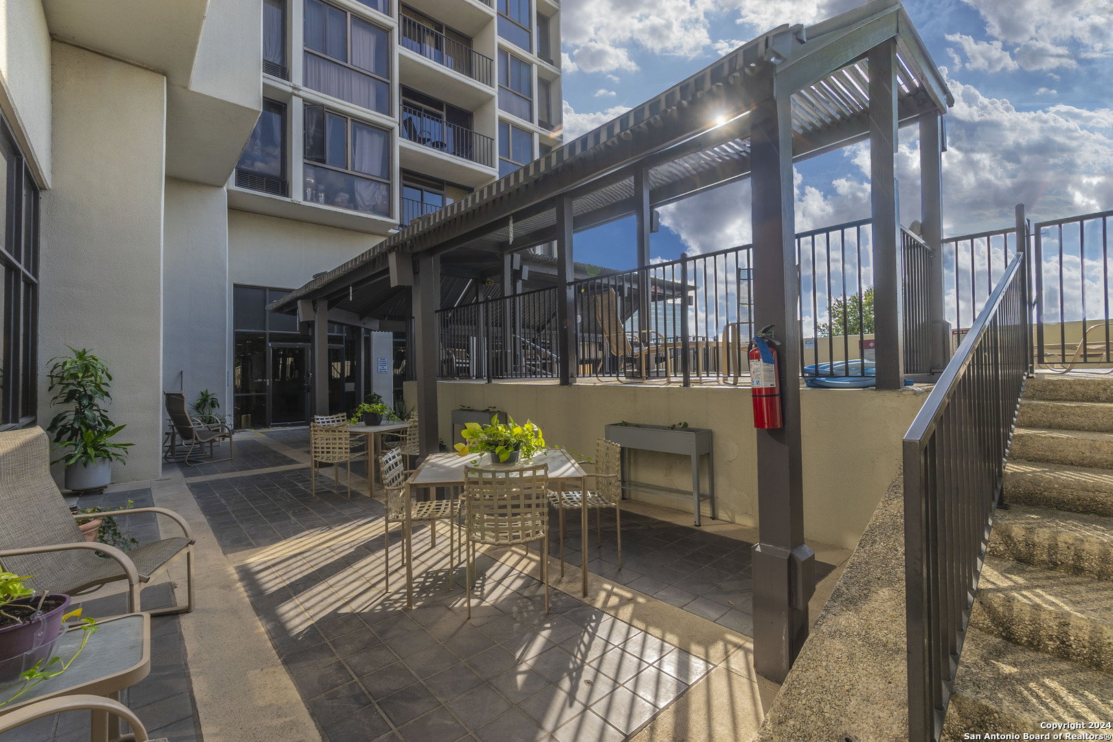 7701 Wurzbach Road, Unit 2302 San Antonio, TX 78229 - Photo 38 of 40 a view of a patio with couches table and chairs and potted plants