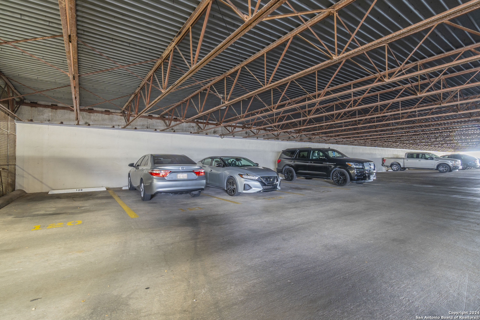 7701 Wurzbach Road, Unit 2302 San Antonio, TX 78229 - Photo 39 of 40 a view of parking garage with cars