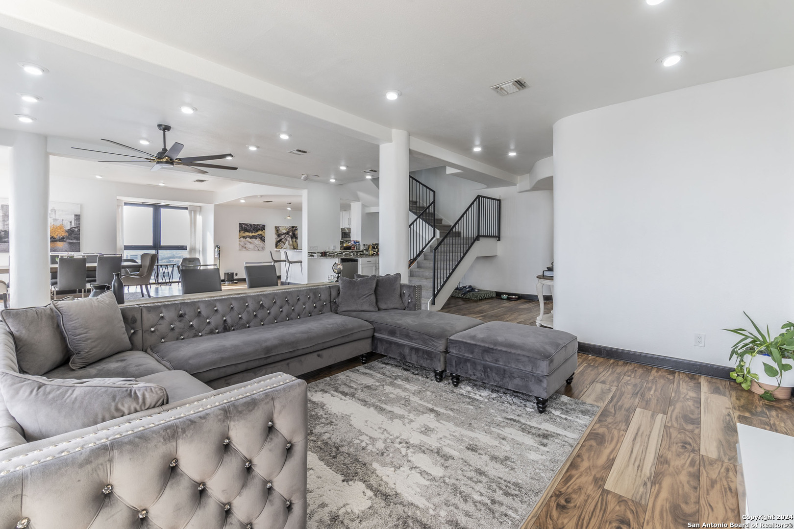 7701 Wurzbach Road, Unit 2302 San Antonio, TX 78229 - Photo 4 of 40 a living room with furniture and wooden floor