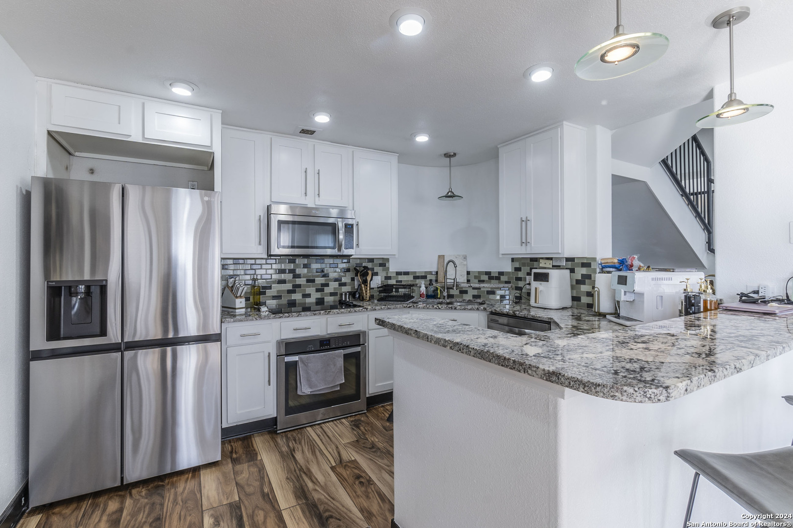 7701 Wurzbach Road, Unit 2302 San Antonio, TX 78229 - Photo 7 of 40 a kitchen with stainless steel appliances granite countertop a sink stove and refrigerator