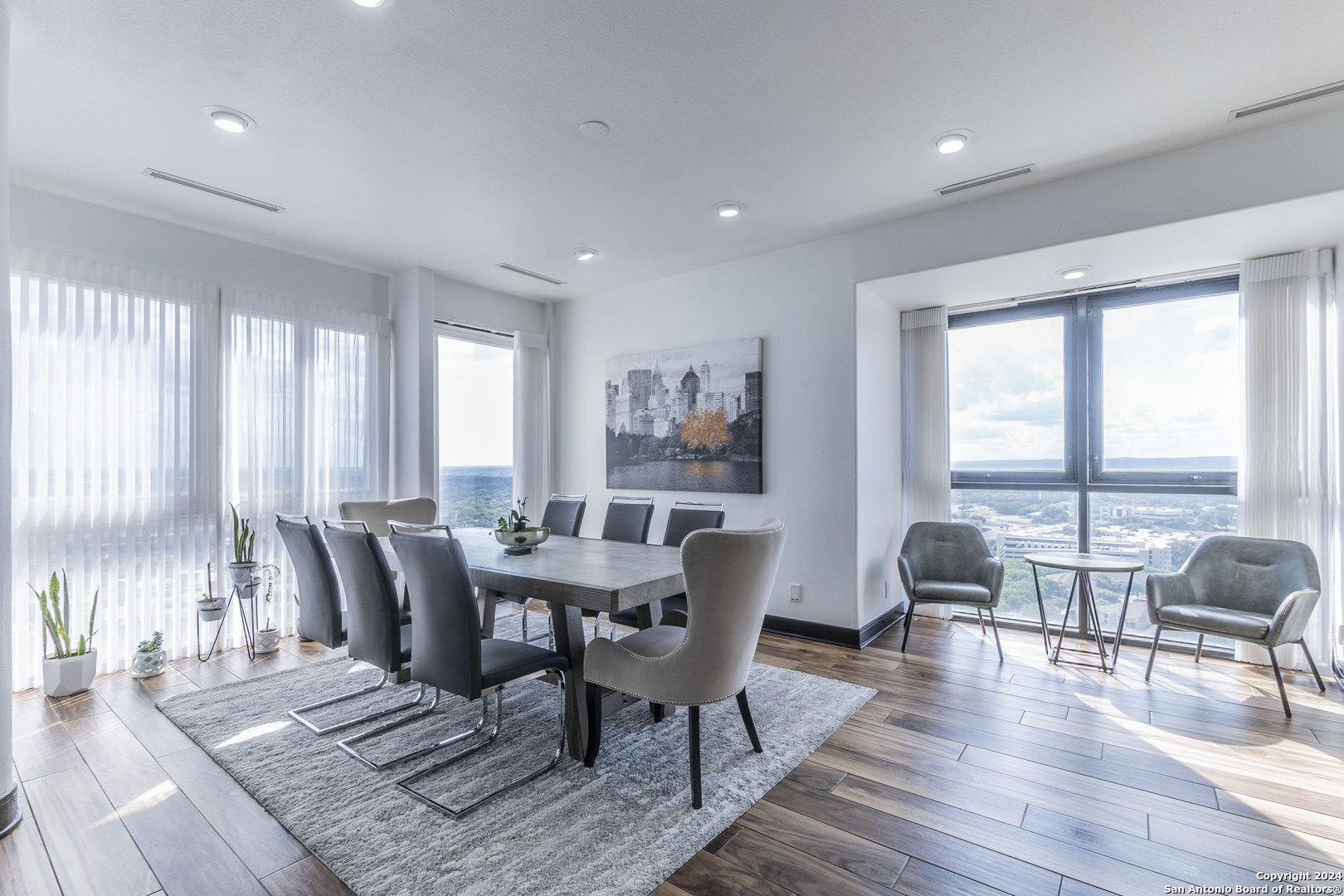 7701 Wurzbach Road, Unit 2302 San Antonio, TX 78229 - Photo 10 of 40 a dining room with furniture window and wooden floor