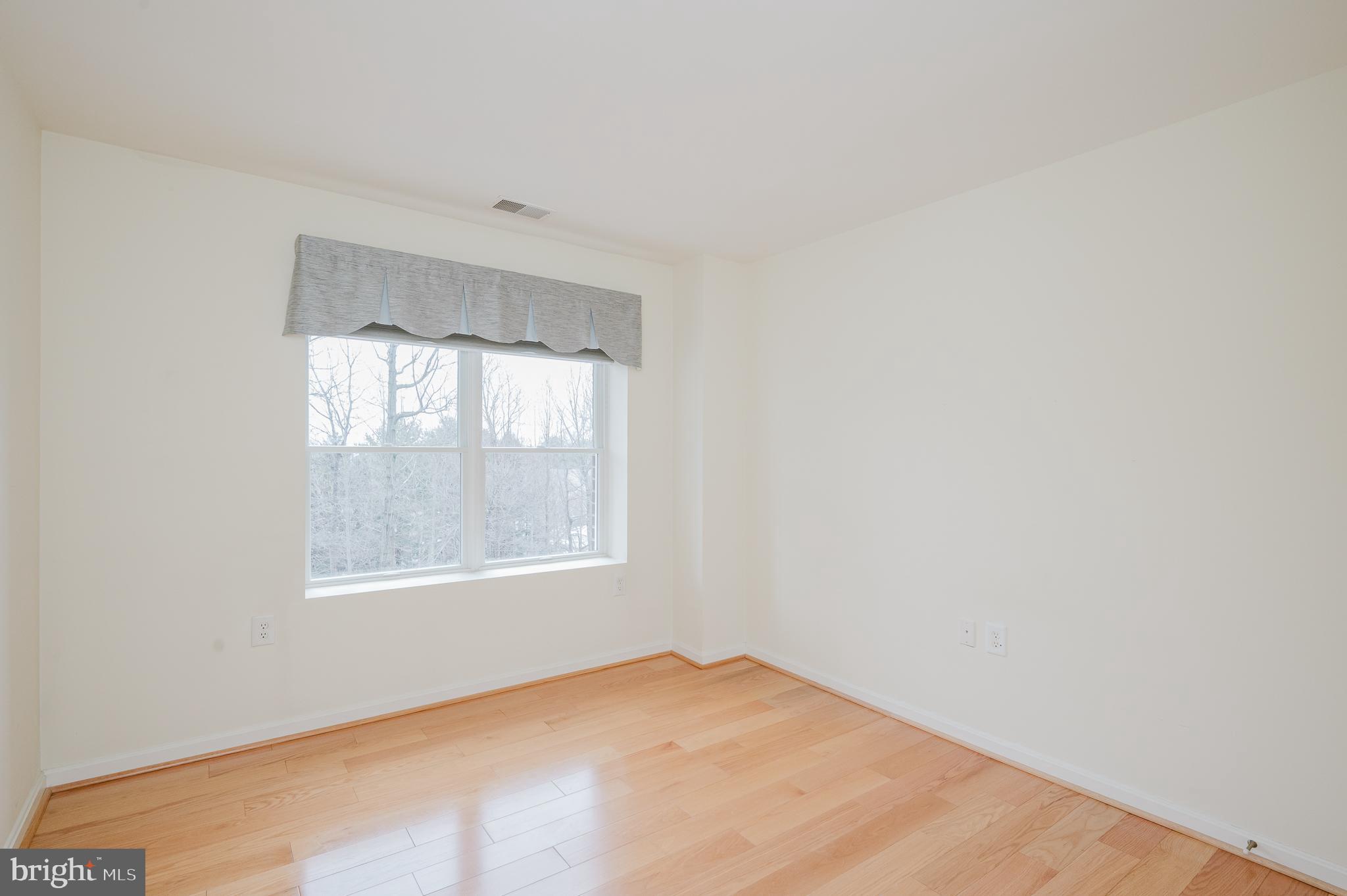 12240 Roundwood Road, Unit 405 Lutherville-Timonium, MD 21093 - Photo 29 of 51 BEDROOM TWO WITH HARDWOOD FLOORING