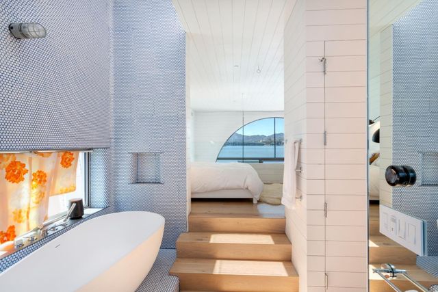 a bedroom with a bed and a mirror