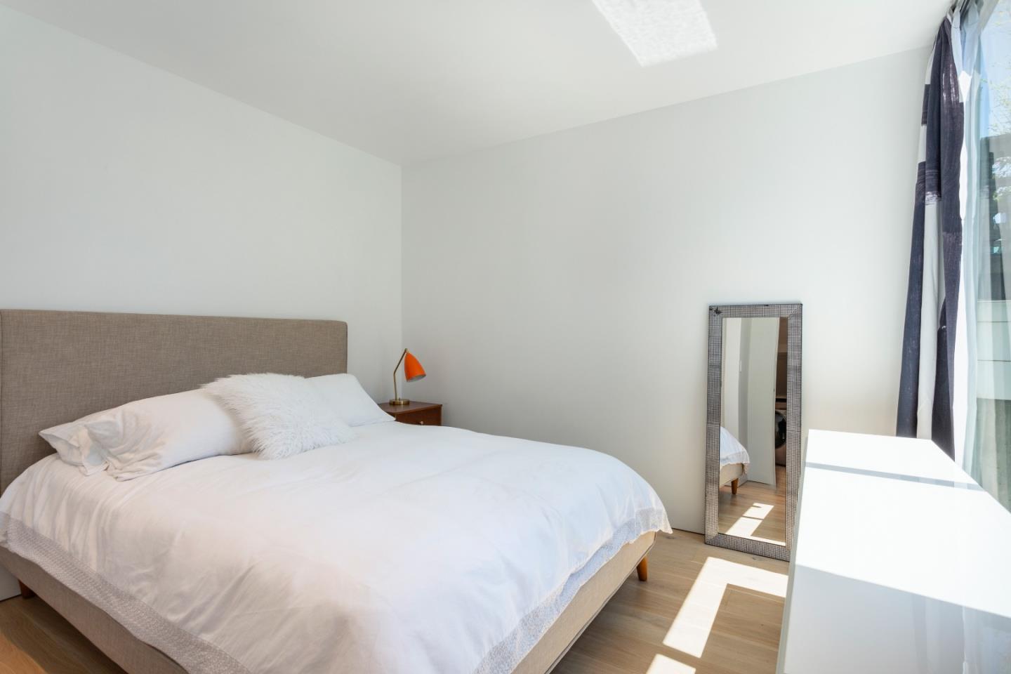 23 Gate 6 1/2 Road Sausalito, CA 94965 - Photo 24 of 34 a bedroom with a bed and a mirror