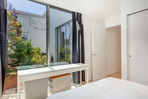 a bedroom with a large bed and a window