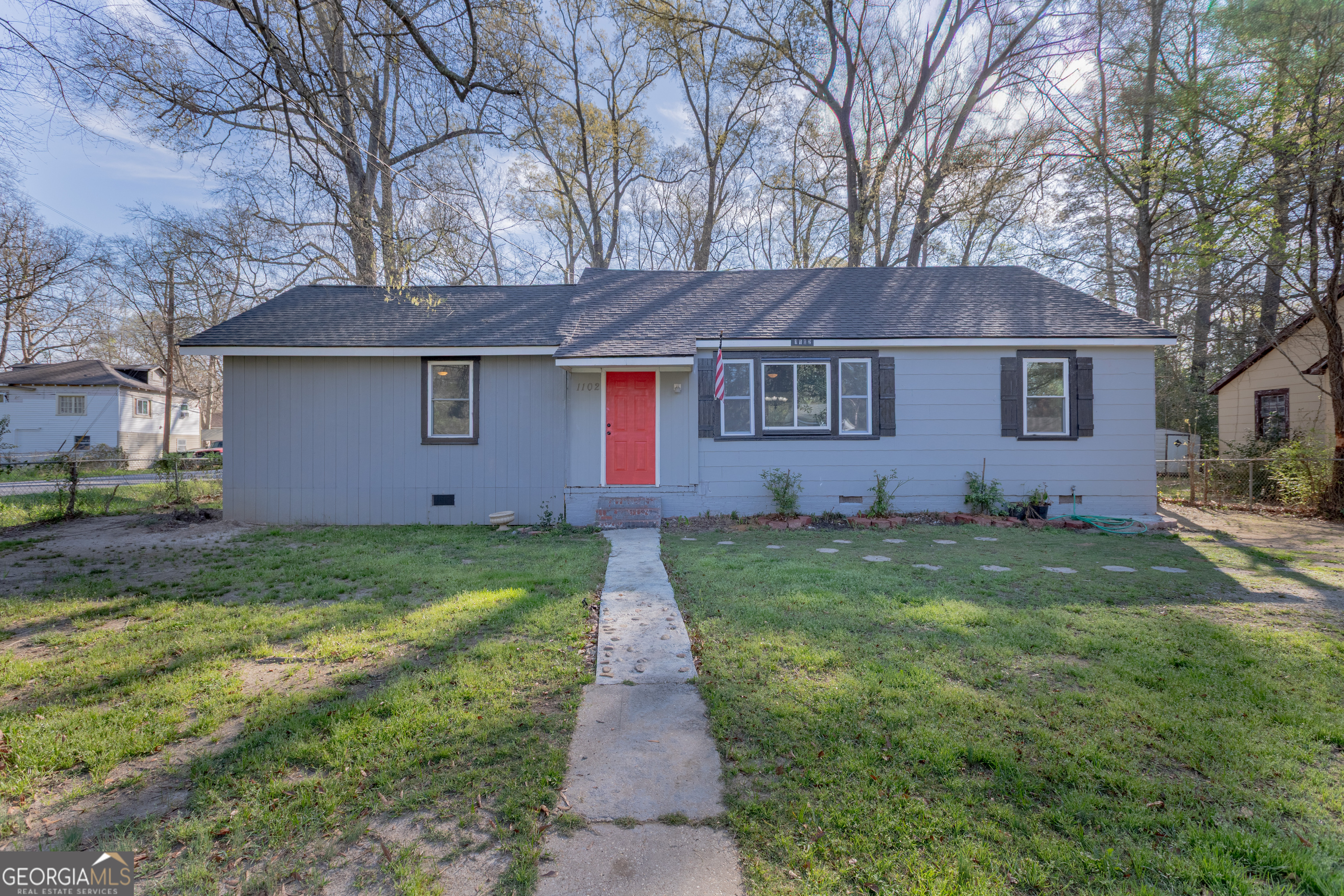 1102 Calvin Avenue Columbus, GA 31903 - Photo 1 of 18 a backyard of a house with lots of green space