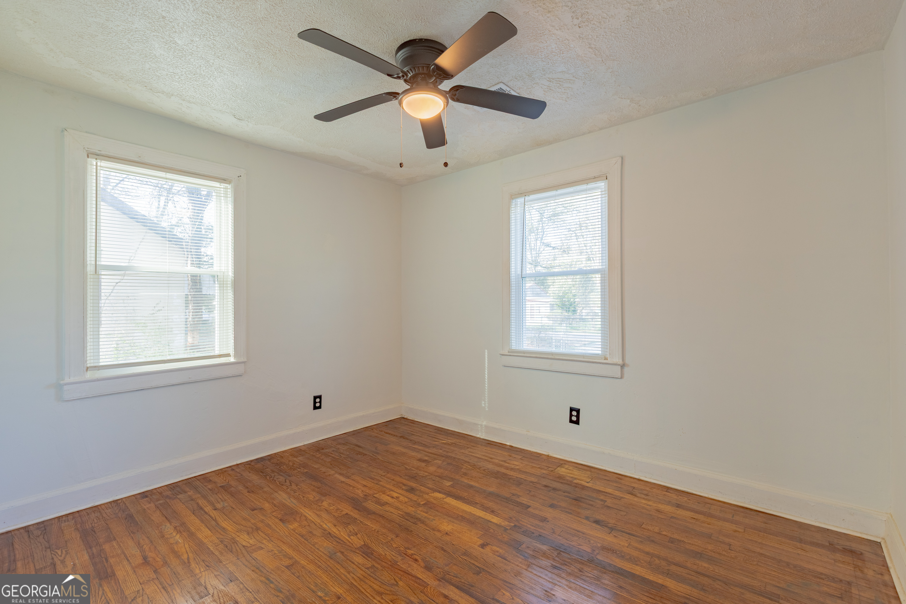 1102 Calvin Avenue Columbus, GA 31903 - Photo 13 of 18 a view of empty room with wooden floor and fan