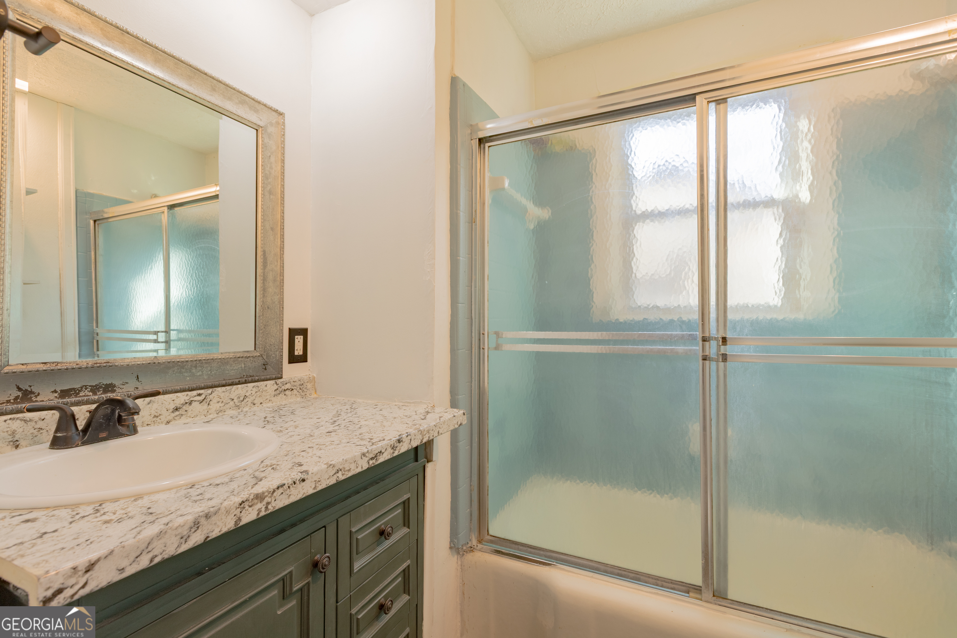 1102 Calvin Avenue Columbus, GA 31903 - Photo 15 of 18 a bathroom with a granite countertop sink and a mirror