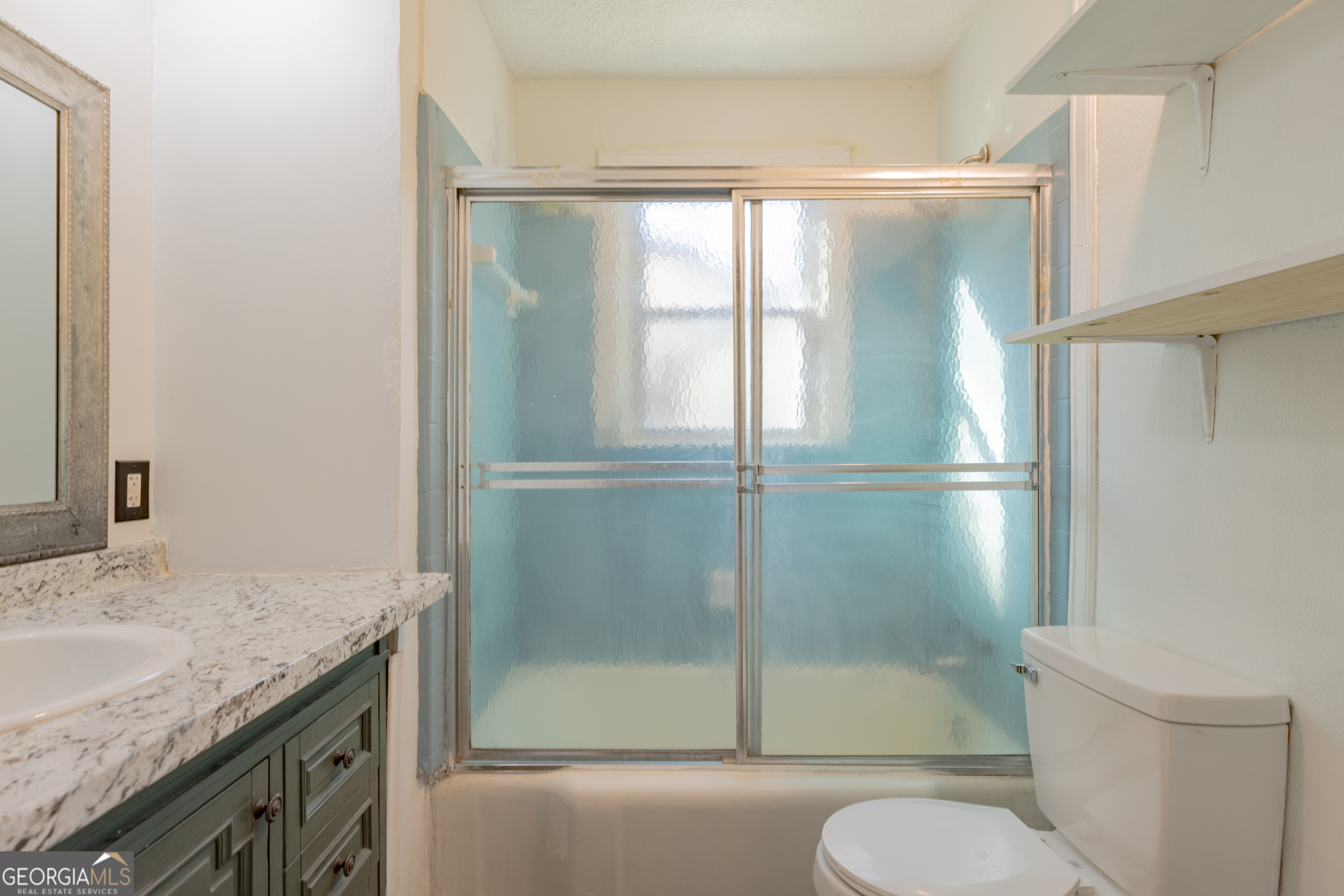 1102 Calvin Avenue Columbus, GA 31903 - Photo 16 of 18 a bathroom with a granite countertop sink toilet and shower
