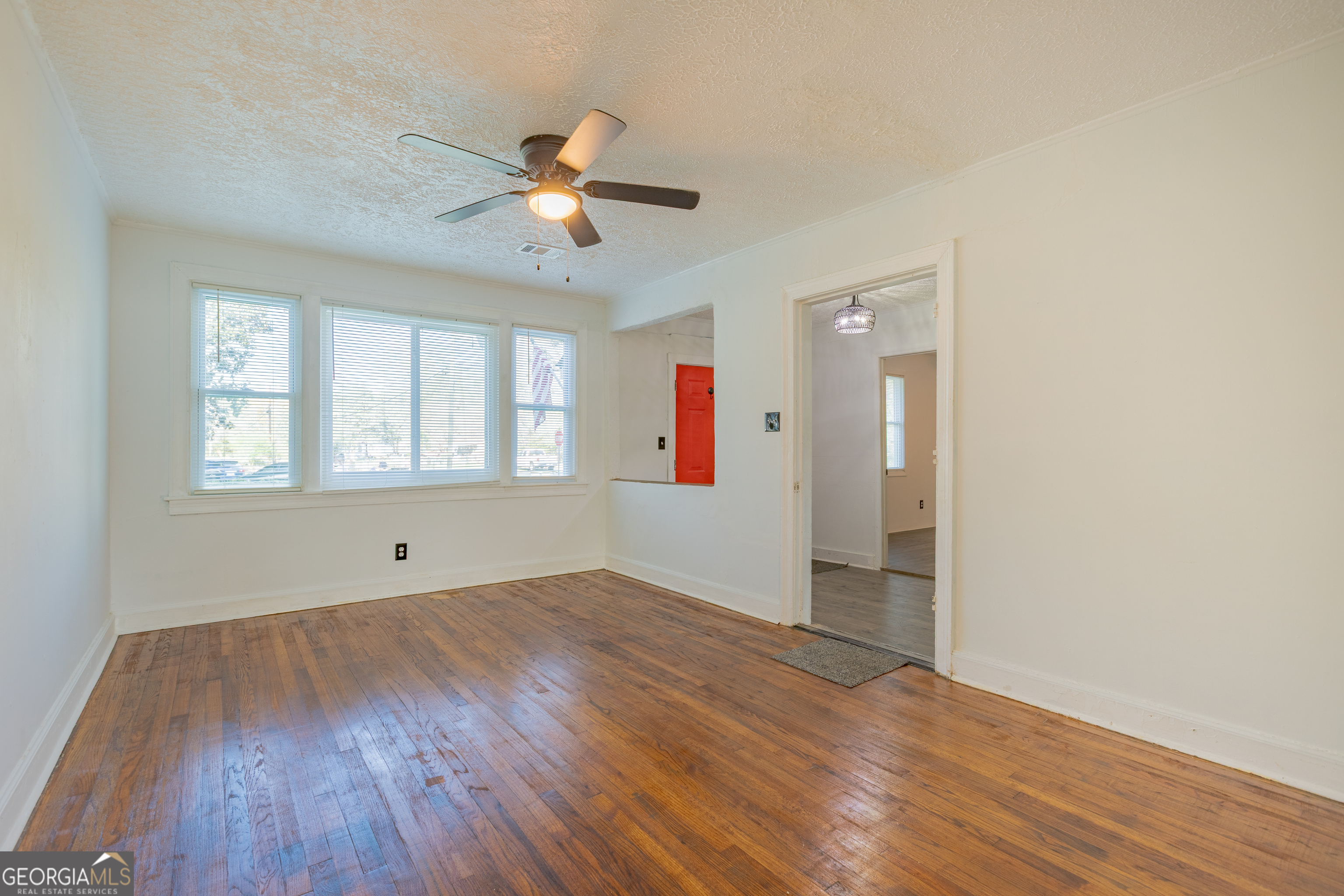 1102 Calvin Avenue Columbus, GA 31903 - Photo 5 of 18 wooden floor in an empty room with a window