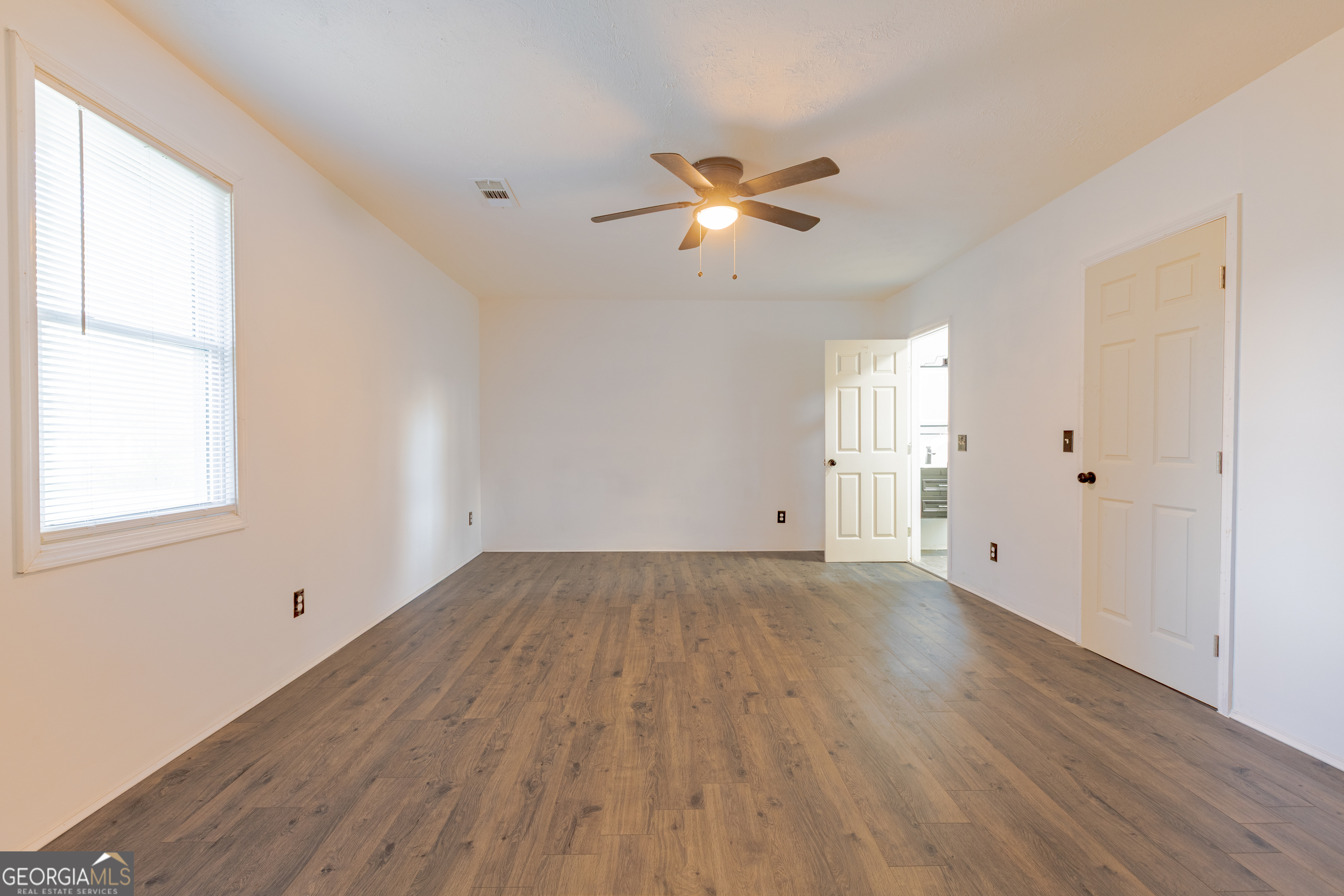 1102 Calvin Avenue Columbus, GA 31903 - Photo 9 of 18 a view of empty room with wooden floor and fan