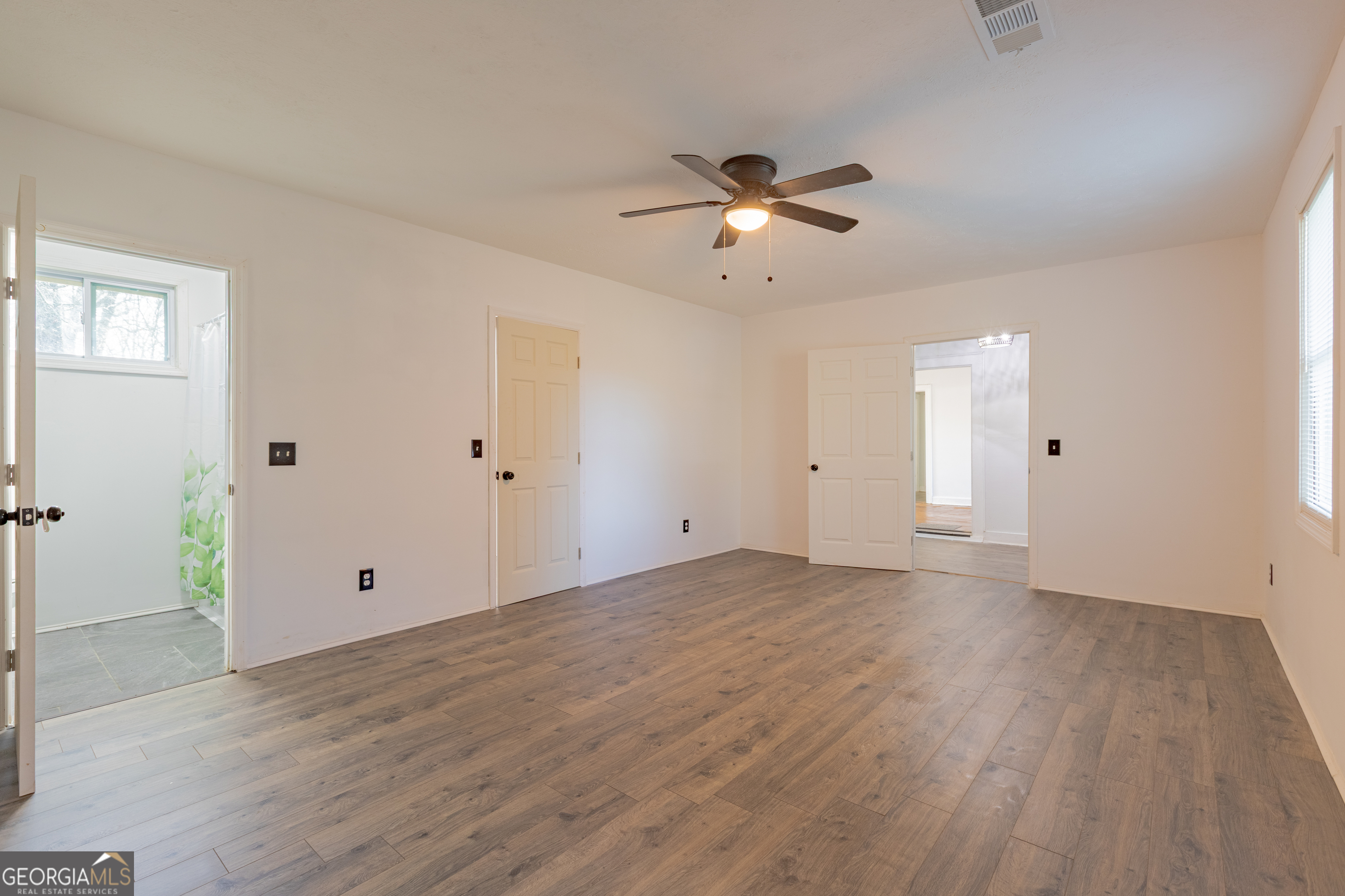 1102 Calvin Avenue Columbus, GA 31903 - Photo 10 of 18 an empty room with wooden floor and ceiling fan