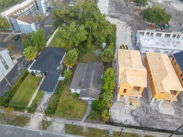 an aerial view of residential houses with outdoor space and street view