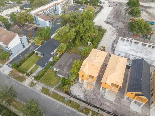 an aerial view of residential houses with outdoor space