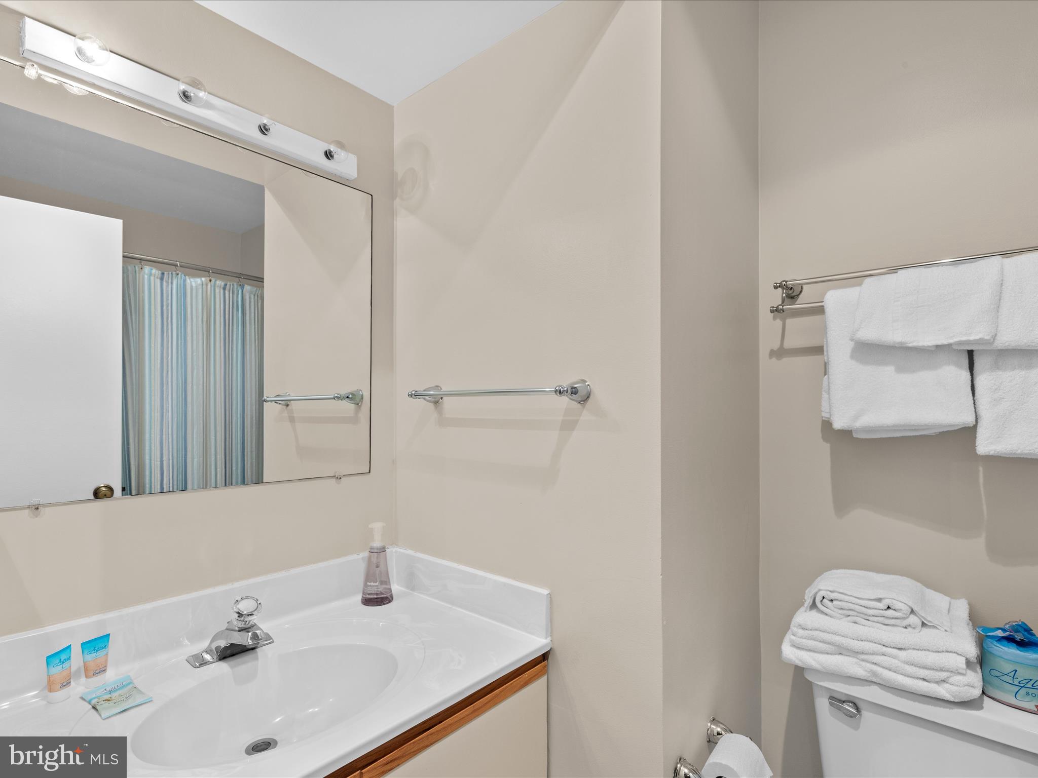 39346 Racquet Lane, Unit 8504 Bethany Beach, DE 19930 - Photo 24 of 40 a bathroom with a sink and a toilet