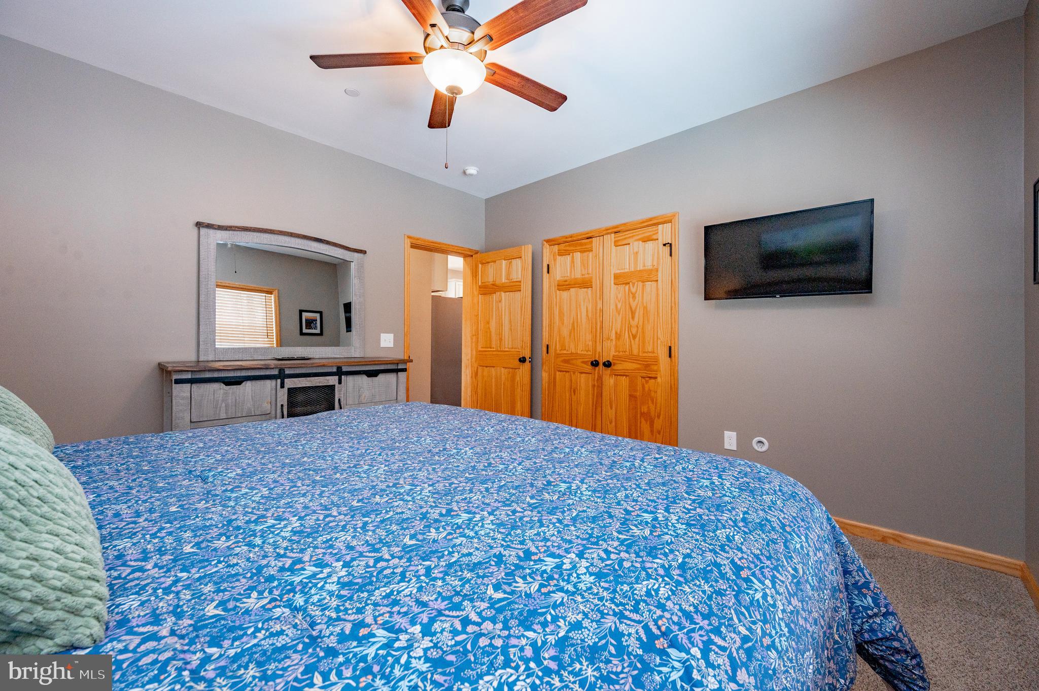 226 Wisp Adventure Road McHenry, MD 21541 - Photo 48 of 67 a bedroom with a bed and a flat screen tv