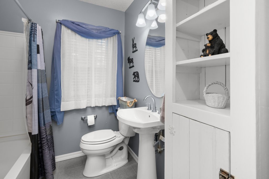 925 12th Avenue Moline, IL 61265 - Photo 19 of 36 a bathroom with a toilet a sink and mirror