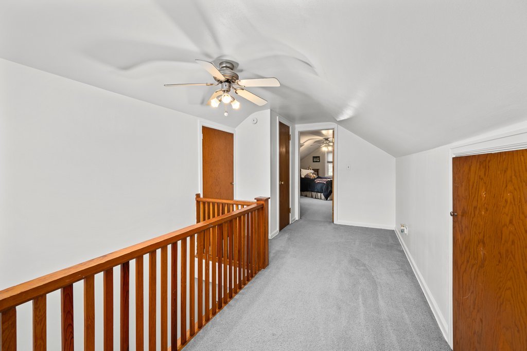925 12th Avenue Moline, IL 61265 - Photo 22 of 36 a view of a hallway with a chandelier fan and windows