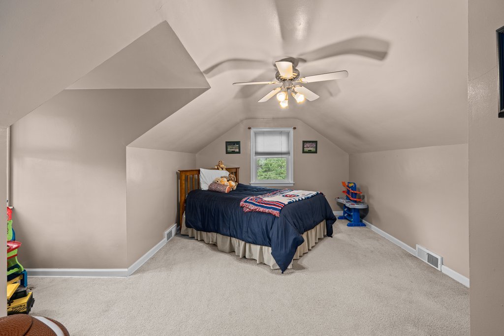 925 12th Avenue Moline, IL 61265 - Photo 23 of 36 a bedroom with a bed and ceiling fan