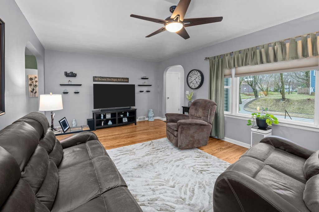 925 12th Avenue Moline, IL 61265 - Photo 4 of 36 a living room with furniture a flat screen tv and a large window