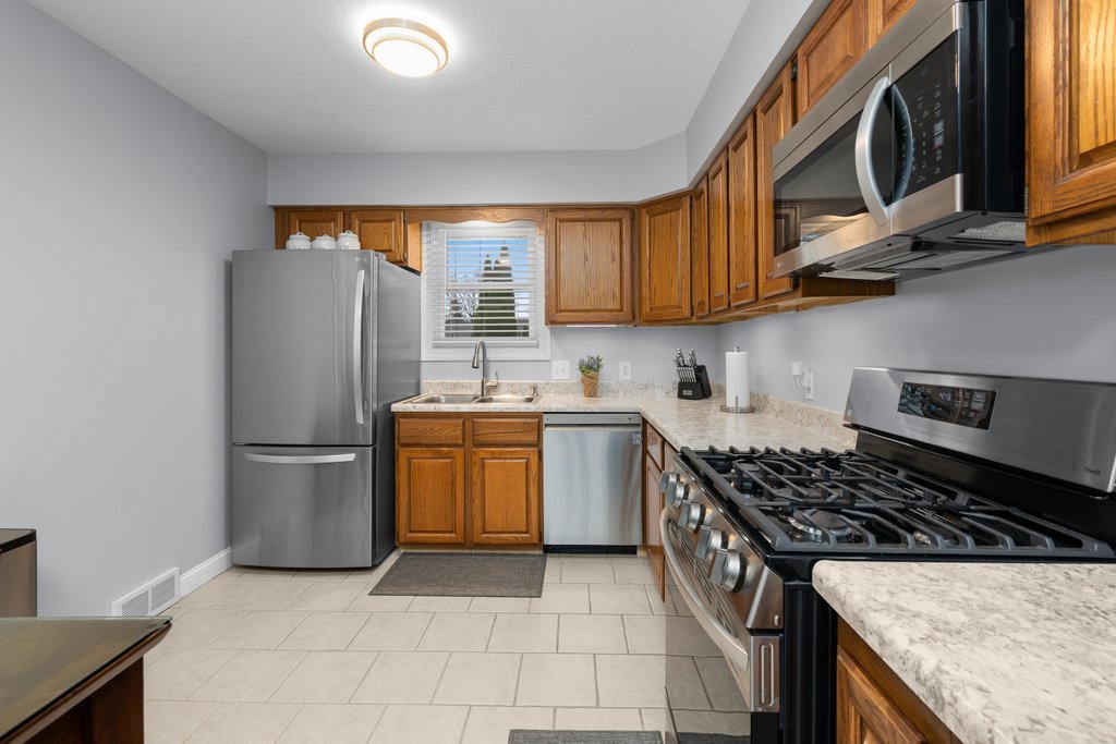 925 12th Avenue Moline, IL 61265 - Photo 10 of 36 a kitchen with stainless steel appliances granite countertop a stove a refrigerator and a sink