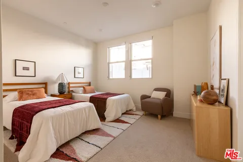 a bedroom with two beds and a window