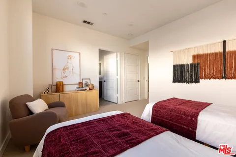 a bedroom with furniture and wooden floor