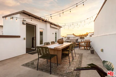 a view of a patio with table and chairs