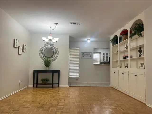 a view of kitchen with refrigerator and window