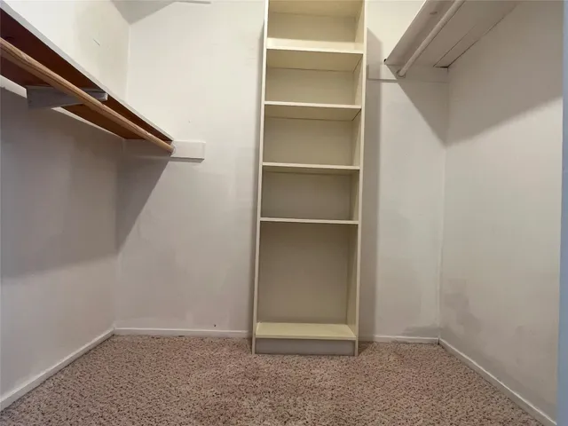 a bathroom with a sink toilet and window