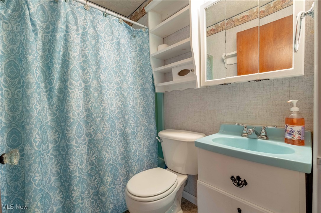 15544 West Calla Road Beloit, OH 44609 - Photo 27 of 40 Full bathroom with vanity, decorative backsplash, and curtained shower