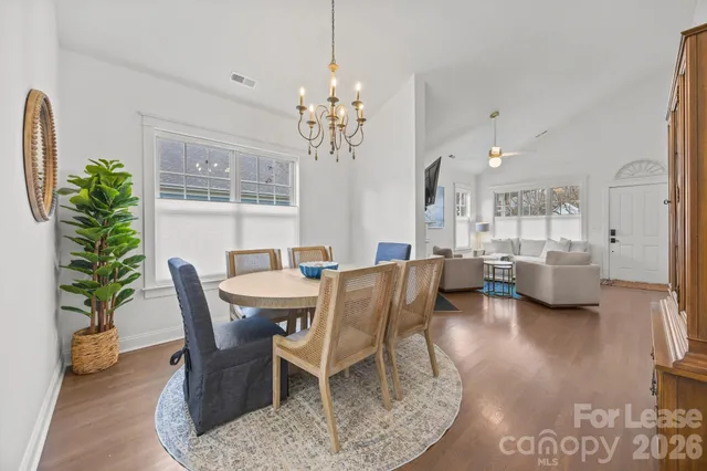 a view of a dining room with furniture and a chandelier