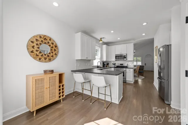 a kitchen with a refrigerator and a stove top oven