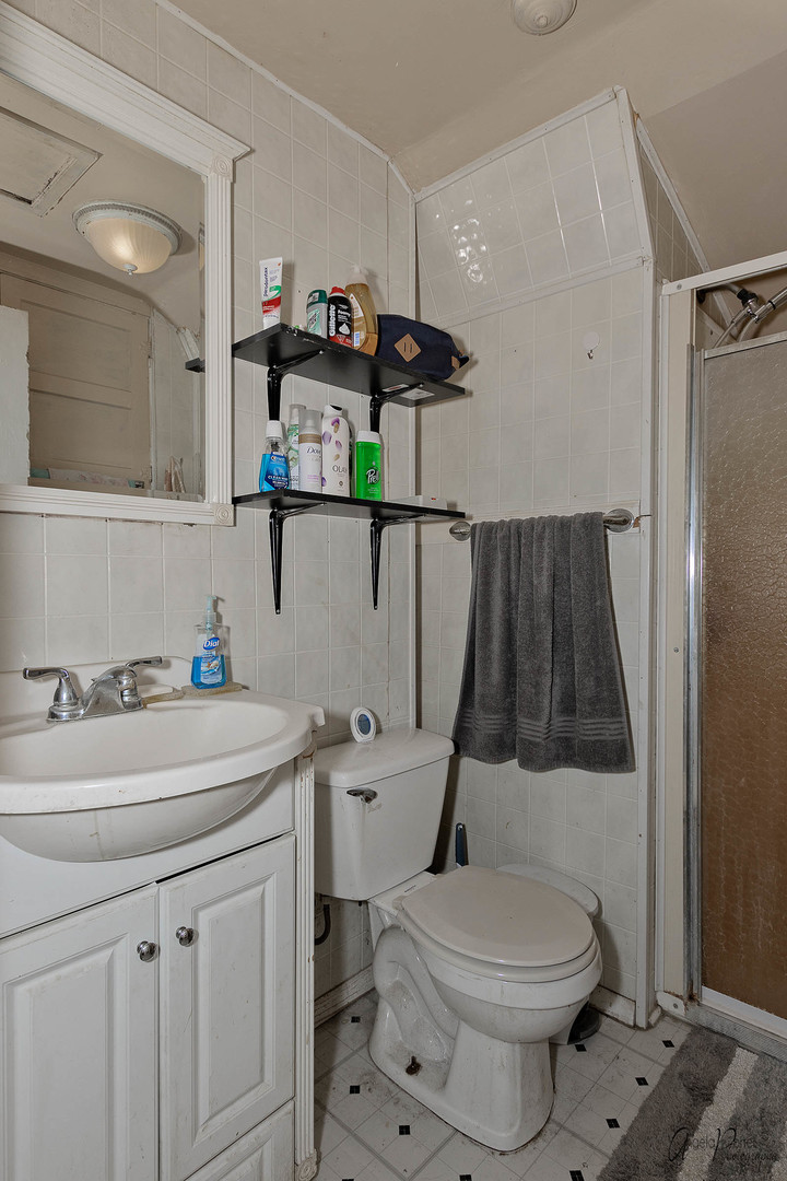 26308 West Rollins Road Ingleside, IL 60041 - Photo 17 of 26 a bathroom with a sink a toilet and a mirror